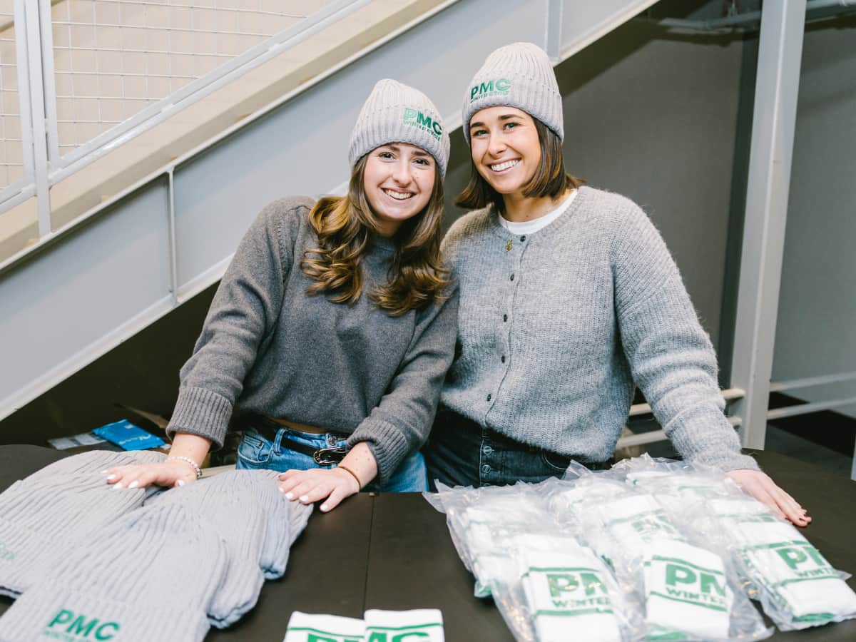 M&T Bank employees hand out PMC Winter Cycle hats and socks at Fenway Park