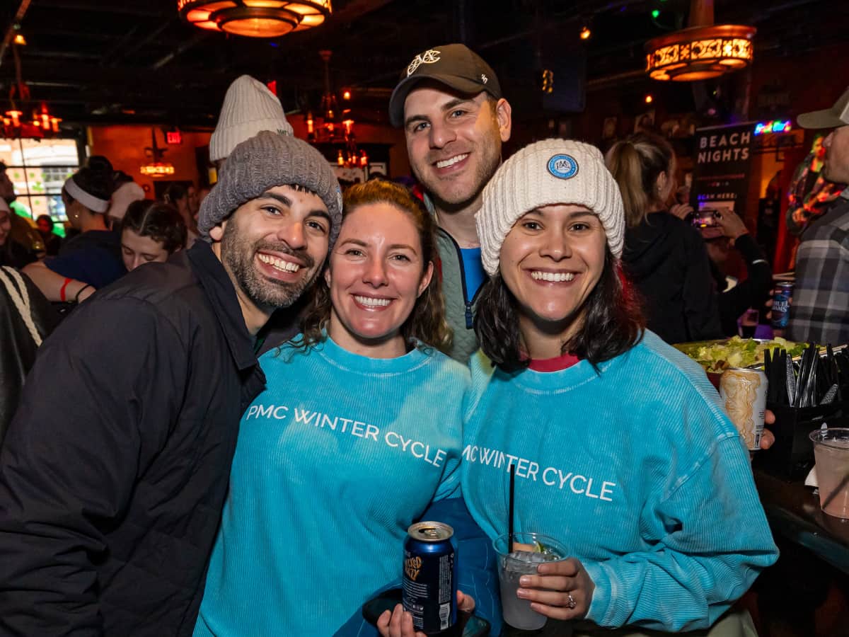 PMC Winter Cycle riders and volunteers pose together at the PMC Winter Cycle After Party at Lansdown Pub